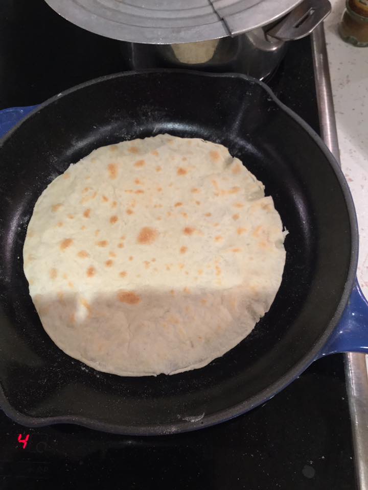 The tortilla in the cast iron pan