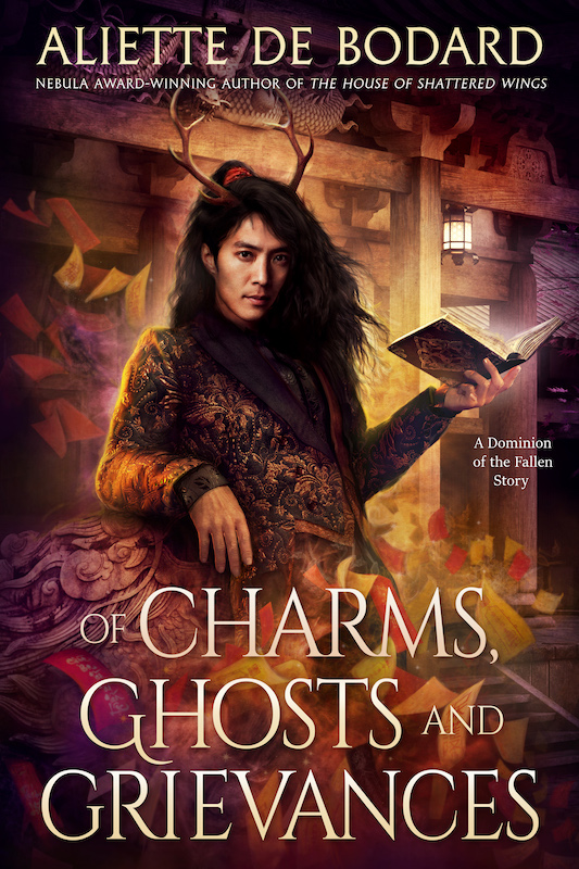 Cover of Of Charms, Ghosts and Grievances, showing a man with antlers smoulderingly leaning against a dragon statue and holding a glowing book